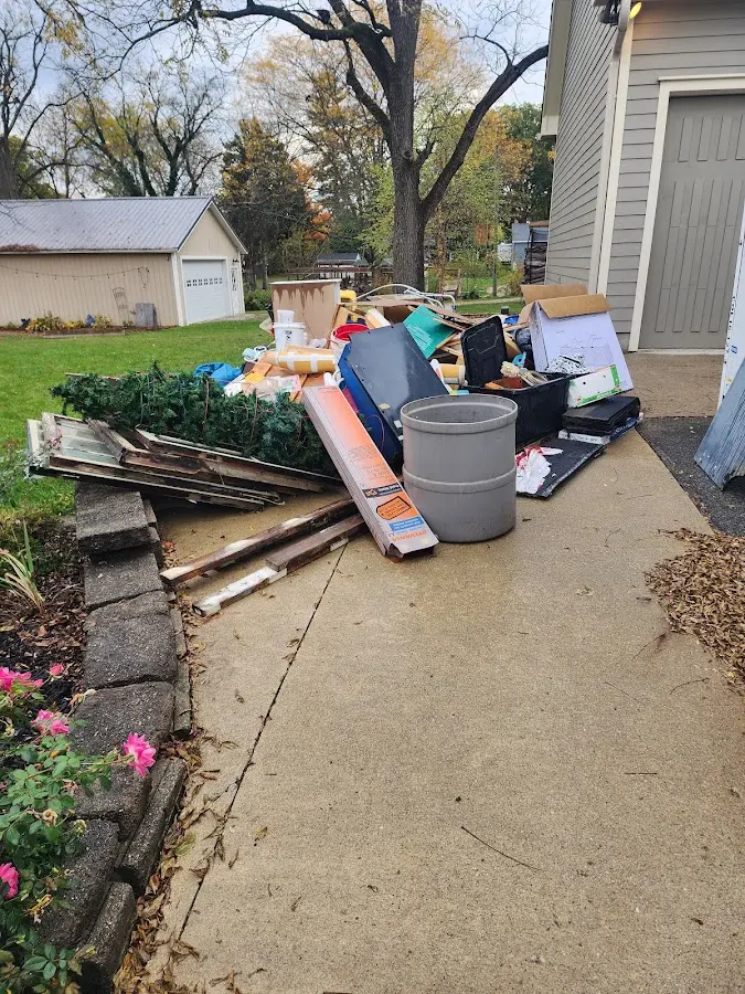 Dumpster being loaded with debris for Estate Cleanout Dumpster Rental in Hancock